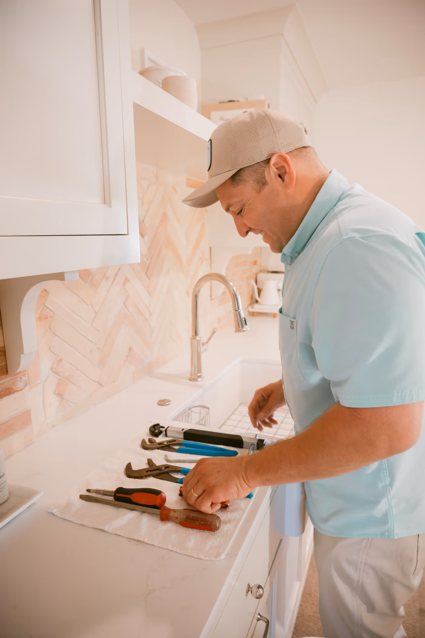 Gabe Sandersius working at a new kitchen fixture